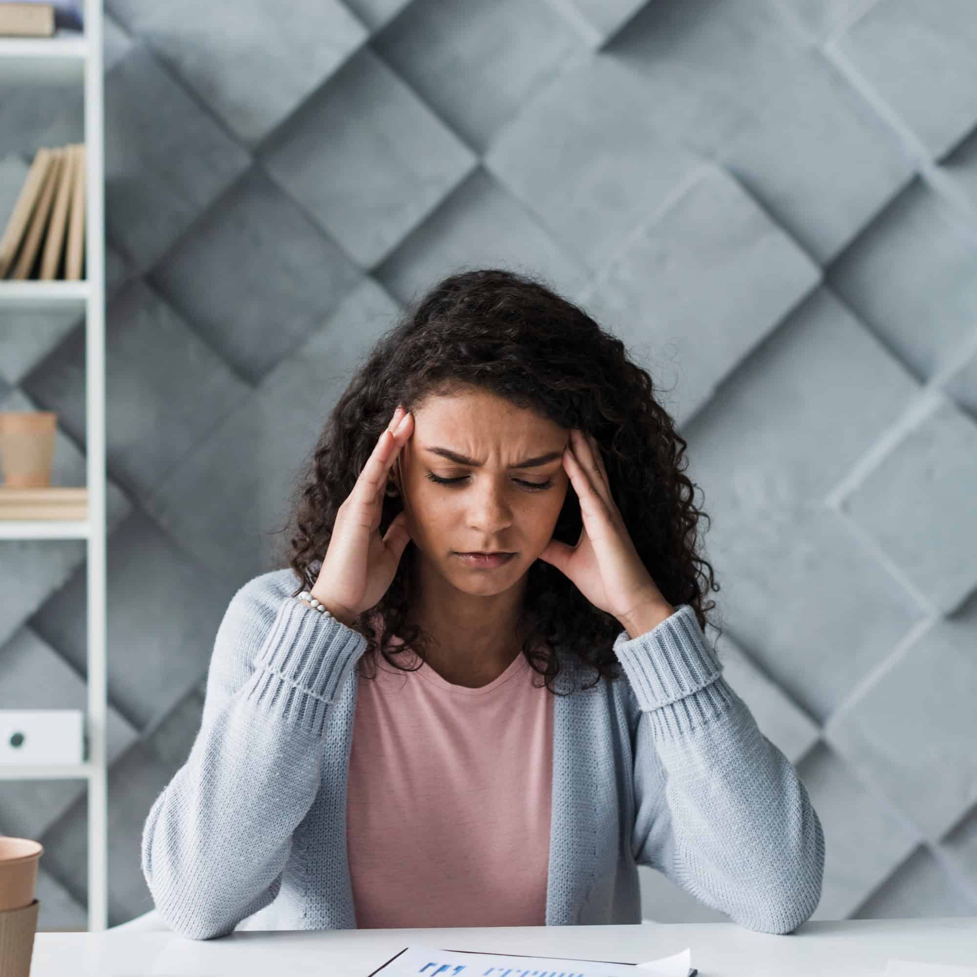 Woman experiencing a headache while seeking support during drug detox in Bowling Green, KY at Redstone Behavioral Health.