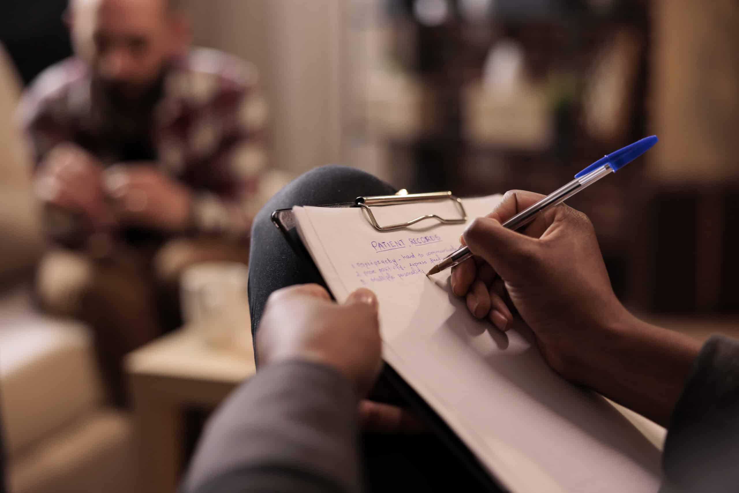 Therapist taking notes during a counseling session at Redstone Behavioral Healthin Bowling Green, KY.
