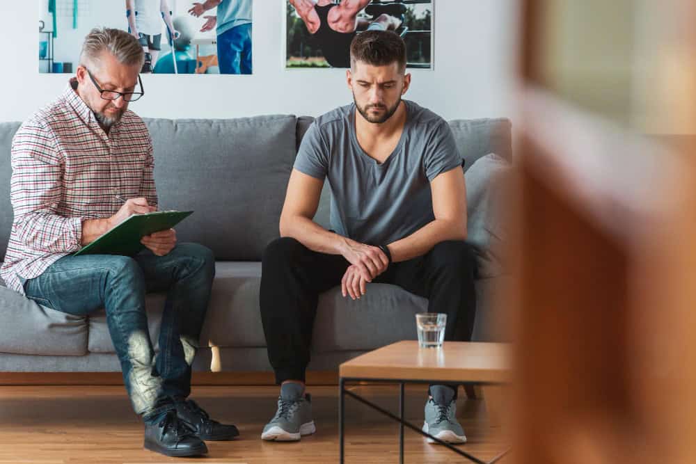 Man and woman talking during a group therapy session related to medical detox in Tennessee.