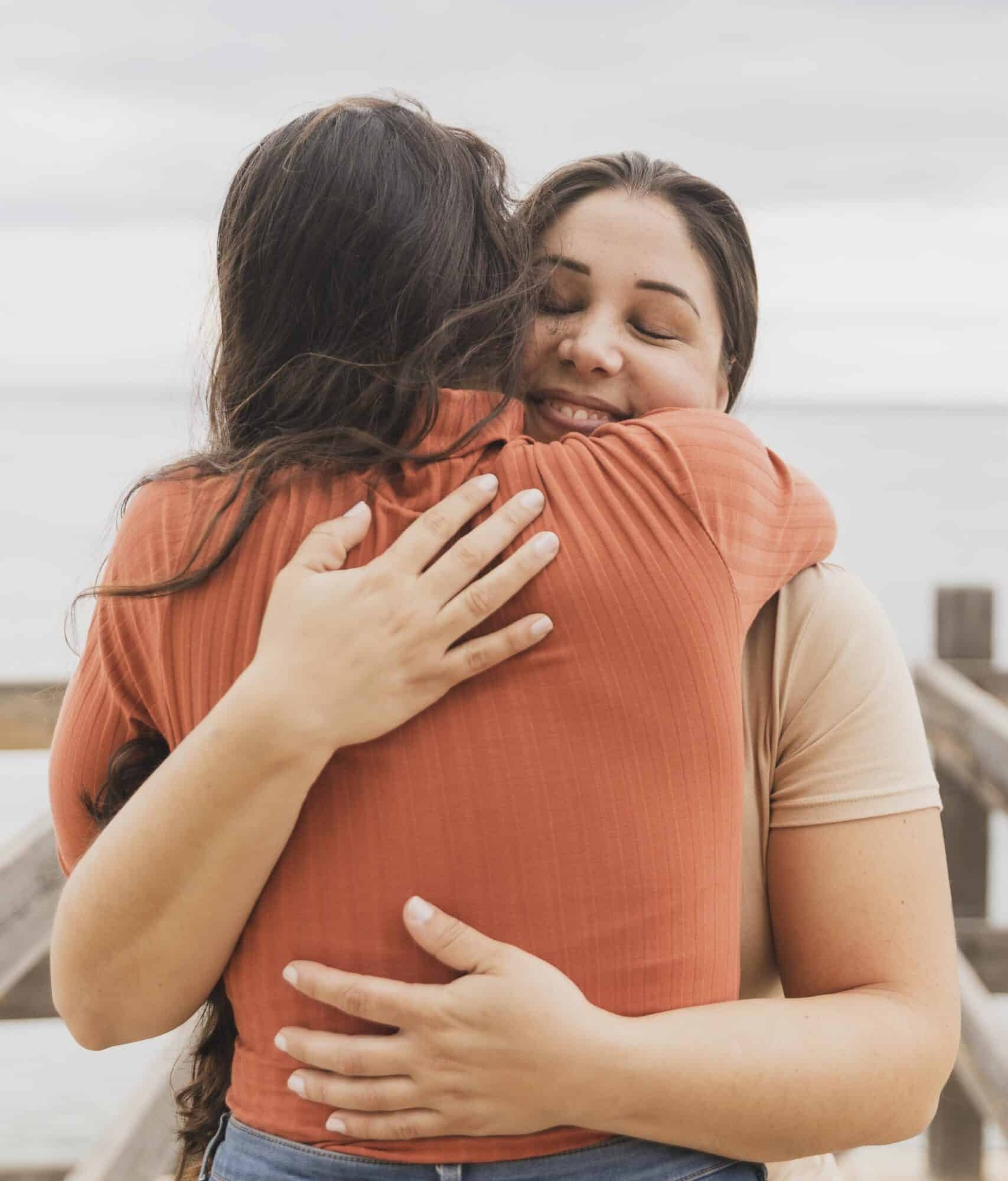 Two women hugging outdoors while offering support during addiction and mental health treatment in Bowling Green, KY.